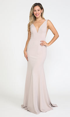 A woman stands smiling against a plain white background, wearing the Sleeveless V-Neck Long Formal Prom Dress 8158 in light beige, featuring a floor-length skirt and deep V-neckline.