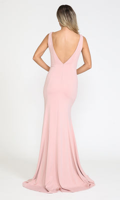 A woman with long, wavy hair models the Sleeveless V-Neck Long Formal Prom Dress 8158 in blush pink, featuring a floor-length skirt and deep V-back, standing against a plain white background.