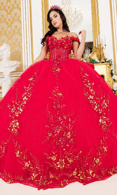 A woman models the Cinderella Couture 8160J quinceanera dress—a luxurious off-the-shoulder ball gown with gold floral embroidery and matching crown—posing indoors in an elegant, gold-accented room.
