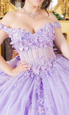 A woman in the Cinderella Couture 8160J off-shoulder lavender quinceanera dress, adorned with floral accents, lace appliques, and rhinestones, wearing a pearl necklace, stands before an ornate gold mirror.