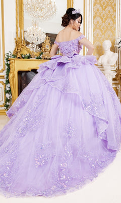 A woman in the Cinderella Couture 8160J off-the-shoulder lavender quinceanera dress with floral embellishments stands in an ornate gold room featuring a chandelier and marble statue.