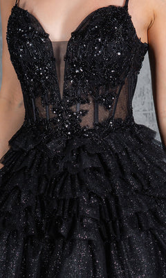A close-up of a person wearing the Glitter Prom Ball Gown: Cinderella Couture 8163J—a sleeveless black dress with sequins, lace appliqué, sheer panel, and tiered ruffled layers, evoking a glamorous A-line silhouette.