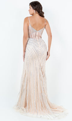 A woman faces away in the Cinderella Couture 8169J long pageant gown, featuring a nude hue with silver sequin embellishments and thin straps, set against a plain white background.