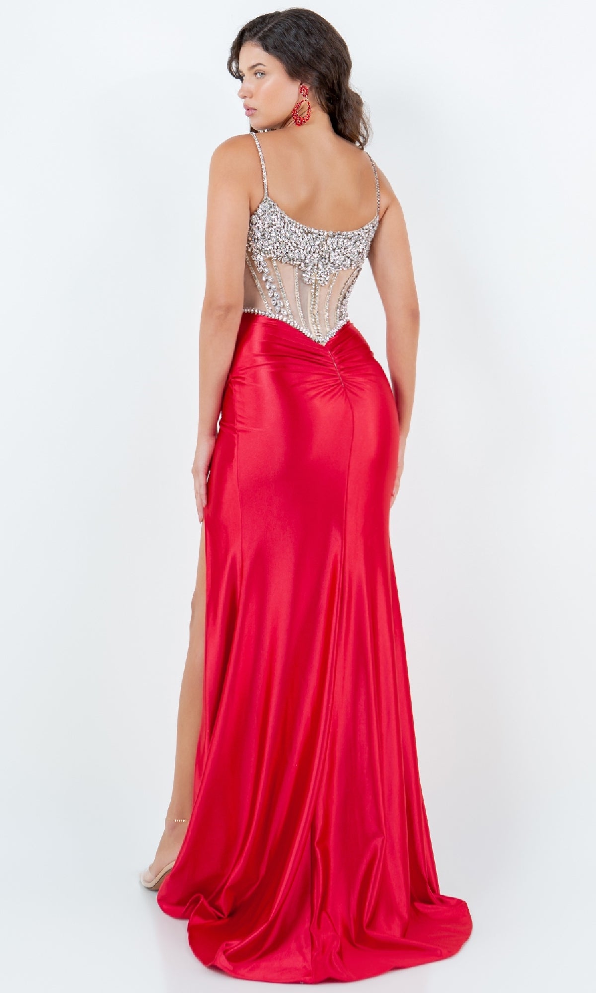 A woman models the Beaded-Bodice Prom Gown (Cinderella Couture 8171J), a sleeveless red satin dress with a jeweled semi-sheer back and high slit, standing against a plain white background.