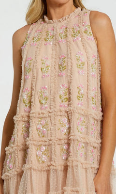 Wearing the Mac Duggal 8172 Short Party Dress, a sleeveless, light pink design adorned with a ruffled grid pattern and elegant green and pink floral embroidery.