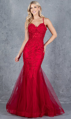 A woman wearing the Lace-Up Long Prom Dress: Cinderella Couture 8175J, a fitted red gown with beaded details and a tulle mermaid skirt, stands against a textured gray background.