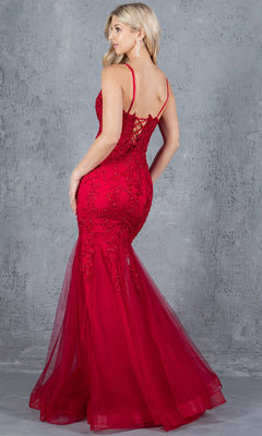 A woman models the Lace-Up Long Prom Dress: Cinderella Couture 8175J, a fitted, floor-length red mermaid gown with beaded lace appliqué and spaghetti straps, standing before a textured gray background.
