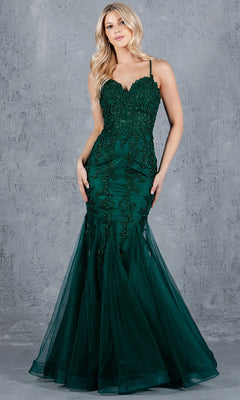 A woman models the Cinderella Couture 8175J, a sleeveless dark green lace-up mermaid prom dress with beaded detailing, standing against a textured gray background.