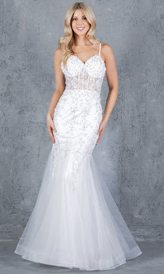 A woman stands against a gray textured background wearing the Cinderella Couture 8175J Lace-Up Long Prom Dress, a white fitted floor-length gown with a sheer skirt and beaded lace appliqué.