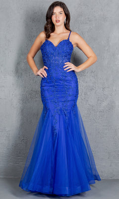 A woman wears the Cinderella Couture 8175J Lace-Up Long Prom Dress, a bright blue fitted gown with beaded lace applique and thin straps, standing against a gray textured background.