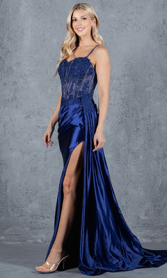 A woman poses before a gray textured wall in the Cinderella Couture 8177J Long Corset Prom Dress, featuring a beaded corset bodice, high slit, and floor-length satin skirt.
