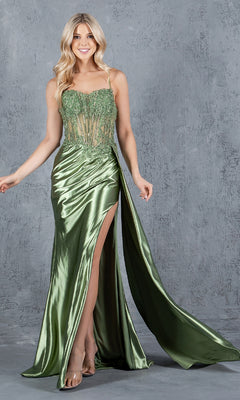 A woman in the Cinderella Couture 8177J long corset prom dress, featuring a shiny green fabric, high slit, sheer beaded bodice, and floral embellishments, stands before a textured gray background.