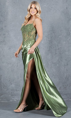 A woman in the Cinderella Couture 8177J Long Corset Prom Dress, with a shiny green beaded bodice and high slit, stands smiling against a textured gray background, looking over her shoulder.