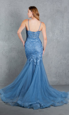 A woman is shown from the back against a gray textured wall, wearing the Cinderella Couture 8178J beaded long prom dress in blue lace and tulle with thin straps and intricate embroidery.