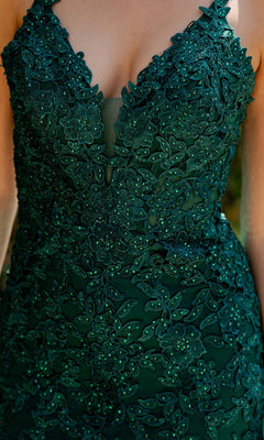 A close-up of a person wearing the Cinderella Couture 8178J Beaded Long Prom Dress in dark green, featuring floral lace patterns and delicate beaded embroidery.