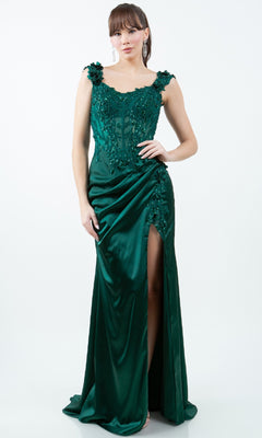 A woman wears the Sparkly Long Prom Dress: Cinderella Couture 8181J—an affordable emerald green, sleeveless, floor-length gown with lace, sequin details, and a high slit—posing against a white background.