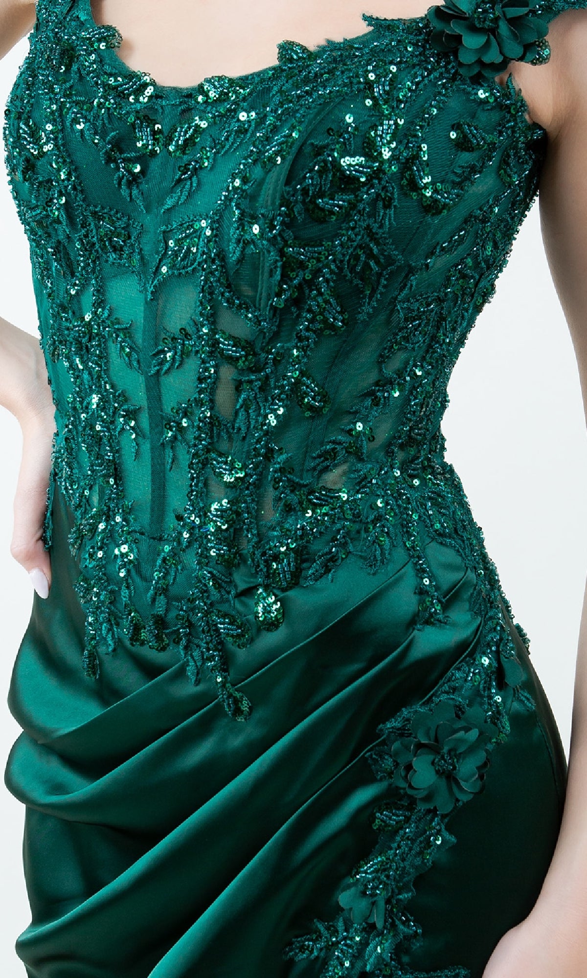 A person wears the Sparkly Long Prom Dress: Cinderella Couture 8181J—a dark green, sequined and beaded evening gown with floral embellishments and draped satin—for a stunning formal look.