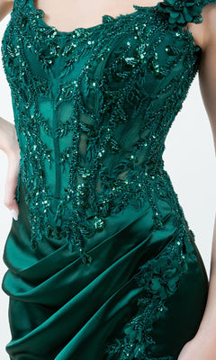 A person wears the Sparkly Long Prom Dress: Cinderella Couture 8181J—a dark green, sequined and beaded evening gown with floral embellishments and draped satin—for a stunning formal look.