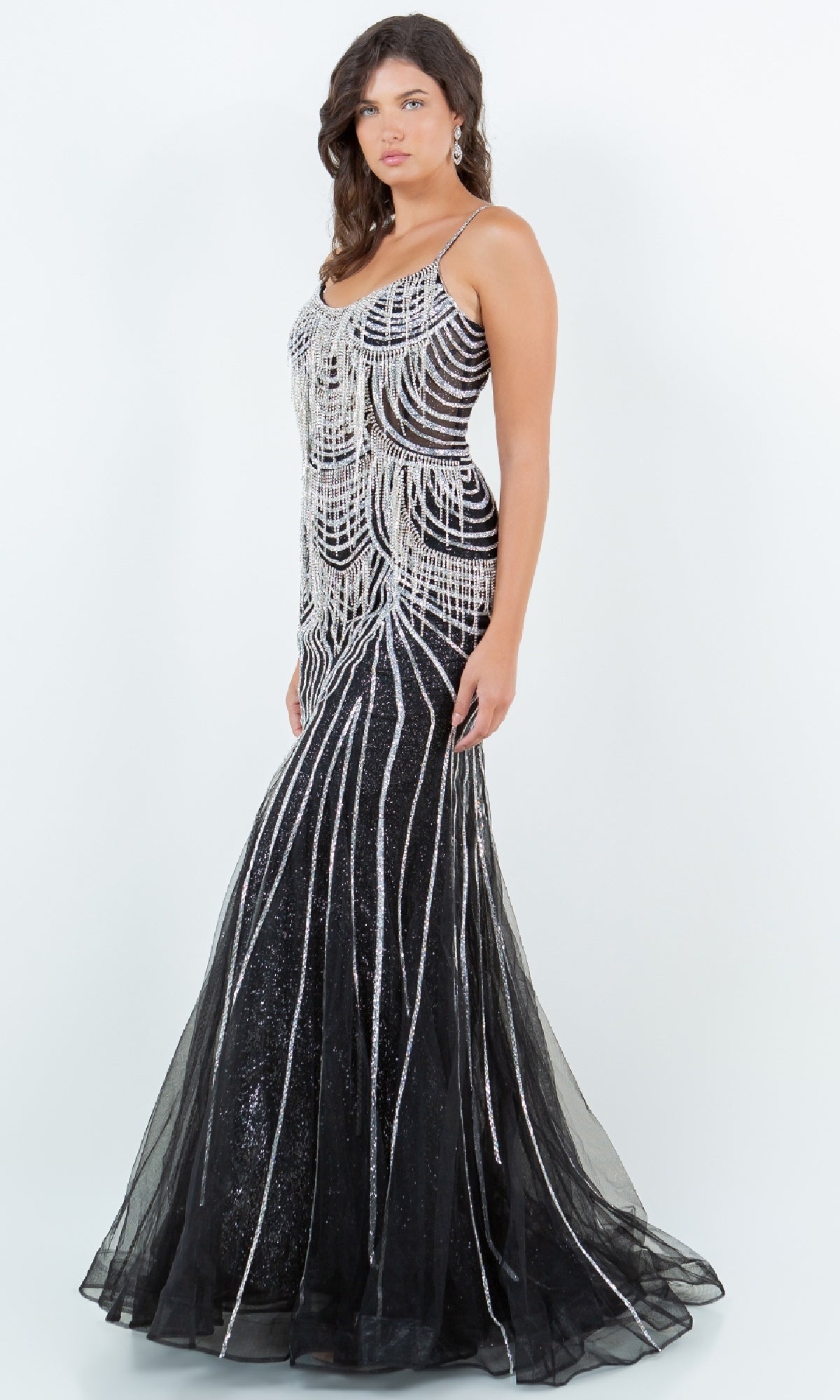 A woman models the Beaded Long Prom Dress: Cinderella Couture 8192J, a black gown adorned with silver sequins and beaded details, standing against a white background.