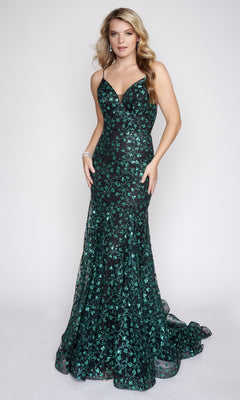 A woman poses against a plain light background in the Long Formal Dress: Nina Canacci 8210—a fitted, dark green and black evening gown with floral embellishments, thin straps, and an adjustable back tie.