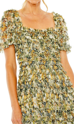 A woman in the Midi Wedding Guest Dress 8232 by Mac Duggal—a semi-formal, short-sleeve dress with green and yellow floral ruffle layers and a square neckline.