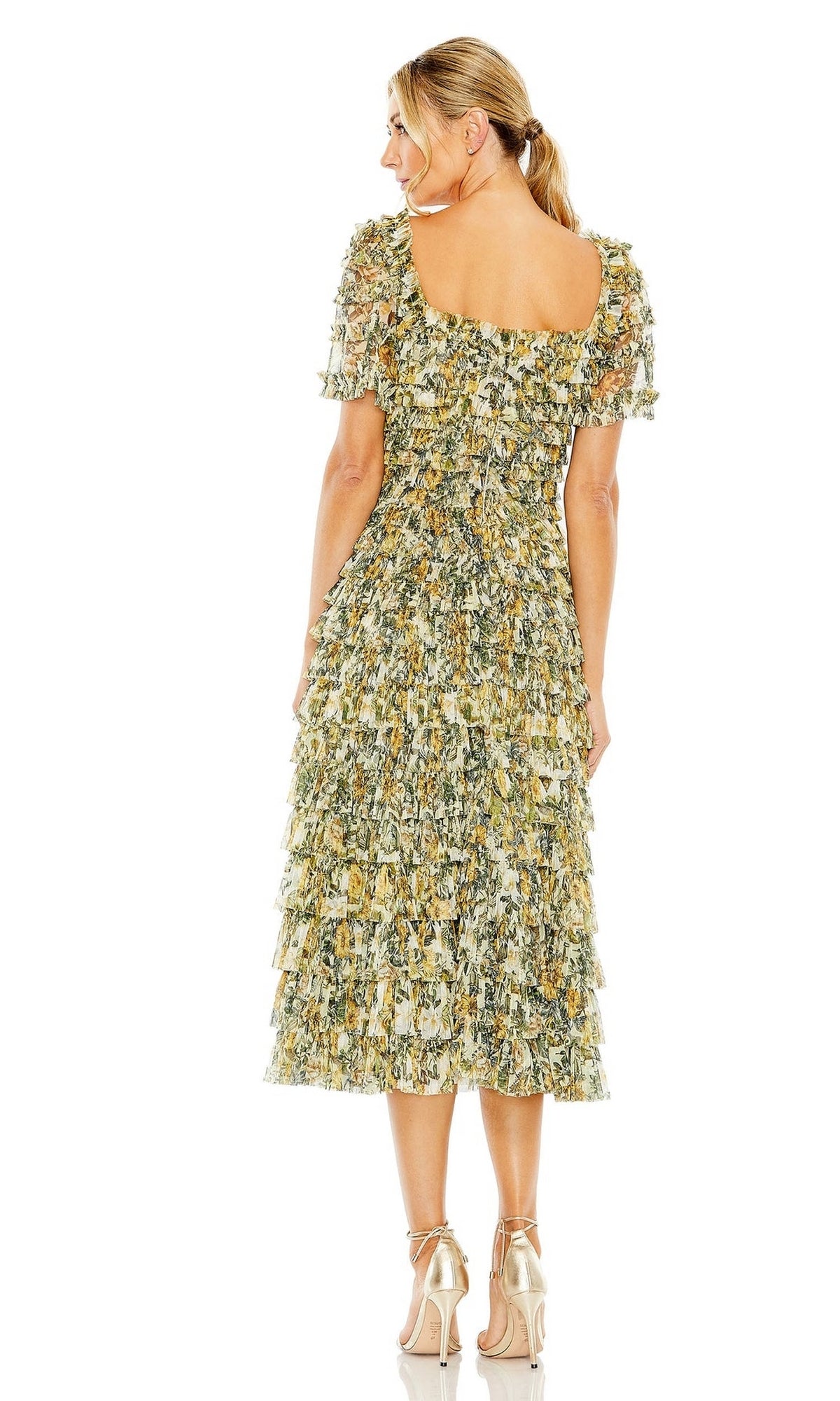 Woman stands facing away in the Midi Wedding Guest Dress 8232 by Mac Duggal, featuring gold ruffle layers, short sleeves, and a square neckline, styled with high-heeled sandals for a chic semi-formal look.