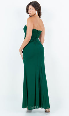 A woman models the Cinderella Couture 8242J Strapless Green Prom Gown—an affordable, floor-length emerald dress with ruching detail; she faces away, glancing over her shoulder.