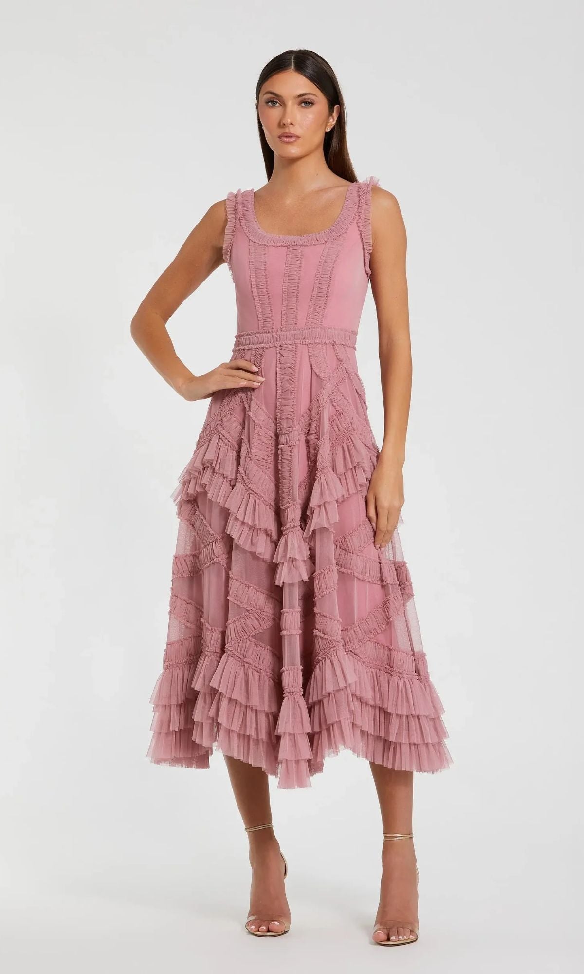 Woman wearing the Mac Duggal 8250 Midi Wedding Guest Dress in Antique Rose, a sleeveless A-line style with layered tiers and micro ruffle details, standing against a plain white background.