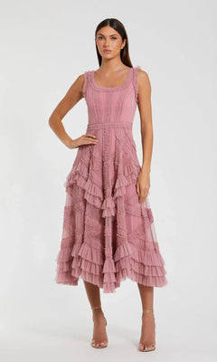 Woman wearing the Mac Duggal 8250 Midi Wedding Guest Dress in Antique Rose, a sleeveless A-line style with layered tiers and micro ruffle details, standing against a plain white background.