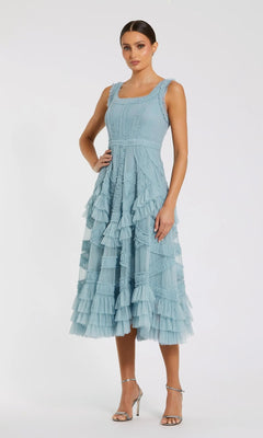 Woman wearing the Midi Wedding Guest Dress: Mac Duggal 8250 in French Blue, a sleeveless A-line with micro ruffles and tiered layers, styled with silver heels—an elegant choice for any wedding guest.