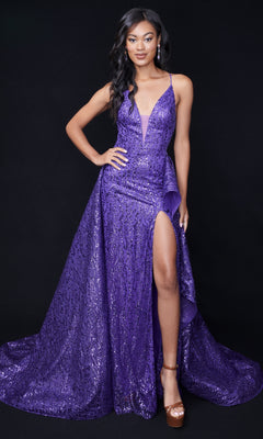 A woman stands against a black background wearing the Nina Canacci 8250 Long Formal Dress, a sparkly purple gown with a thigh-high slit, ruffled overskirt, and brown platform heels.