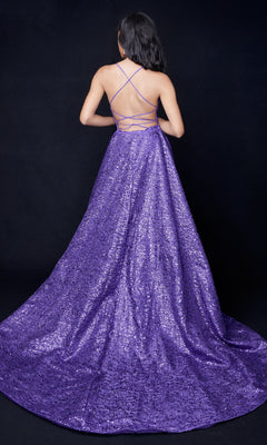 Person wearing a floor-length, backless Nina Canacci 8250 sequin gown with crisscross straps, shown from behind against a black background.