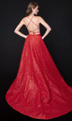 A woman faces away from the camera in a Nina Canacci 8250 long formal dress, showcasing its floor-length glitter design, strappy open back, and fitted bodice against a black background.