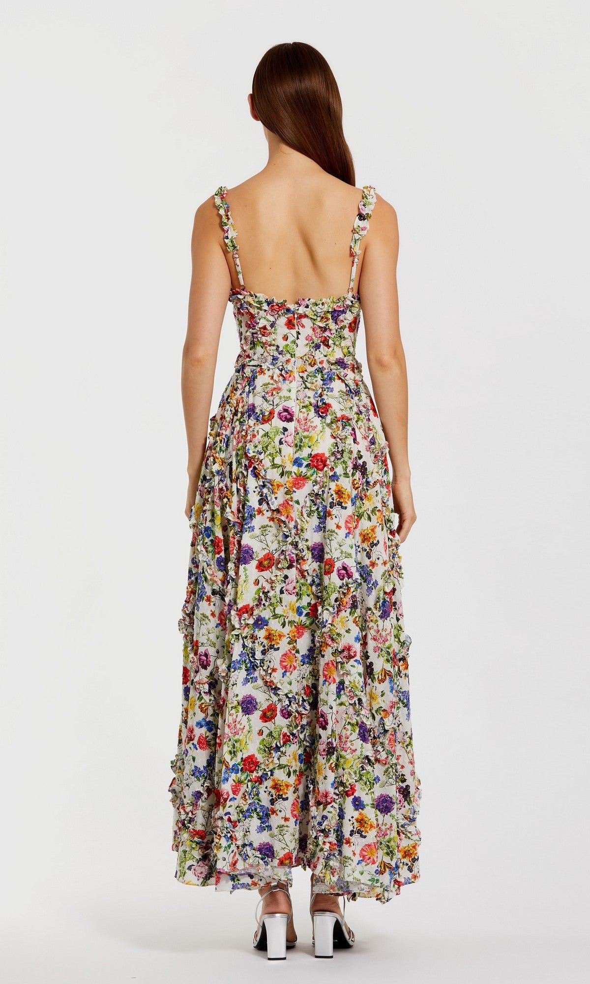 A woman models the Mac Duggal 8256 Floral Wedding Guest Dress—an ankle-length, sleeveless A-line dress with an open back and scoop neckline—facing away from the camera against a white background.