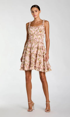 A woman wears the Mac Duggal 8257 Ruffle Short Floral Party Dress, styled with strappy high-heeled sandals, set against a plain light background.
