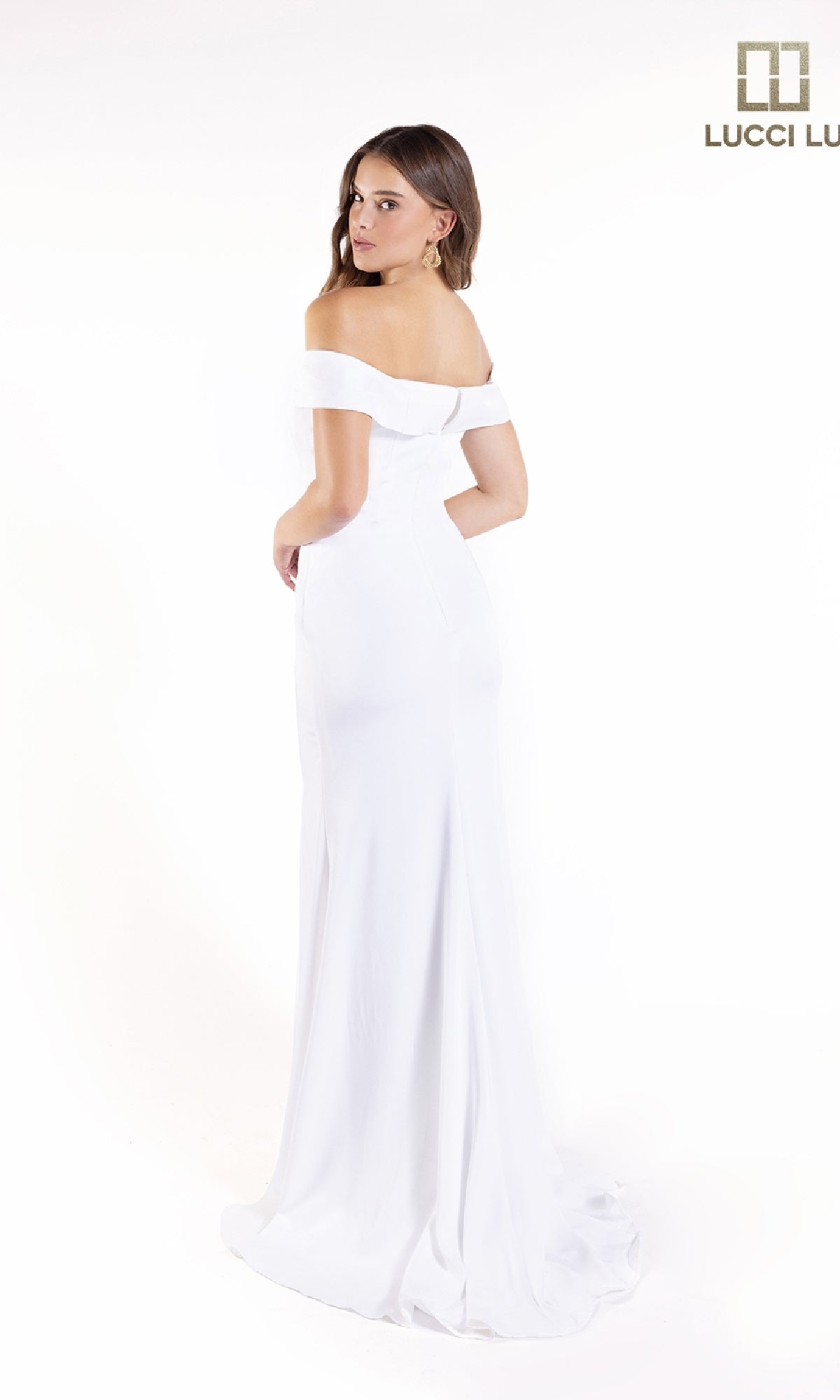 A woman poses in the Off-the-Shoulder Crepe Prom Dress: Lucci Lu 8262, facing slightly away against a plain white backdrop. The Lucci Lu logo in the top right emphasizes this stunning formal gown.