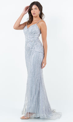 A woman models the Cinderella Couture 8268J—a light blue, floor-length prom dress with thin straps, a sweetheart neckline, and silver sparkly beading—against a plain white background.