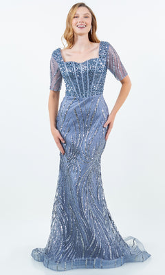 A young woman models the Cinderella Couture 8293M, a floor-length blue sequin mermaid gown with bead accents, short sheer sleeves, and a square neckline, standing against a plain white background.