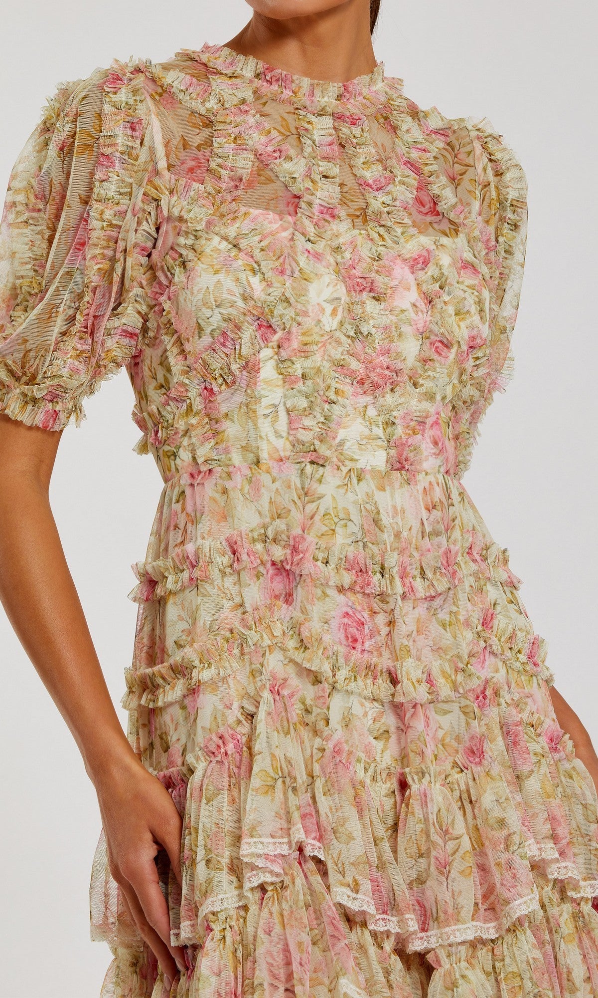 Someone wearing the Mac Duggal 8295 Midi Wedding Guest Dress, which features pastel pink and green floral mesh, sheer fabric, ruffle details, short puff sleeves, and a layered skirt.