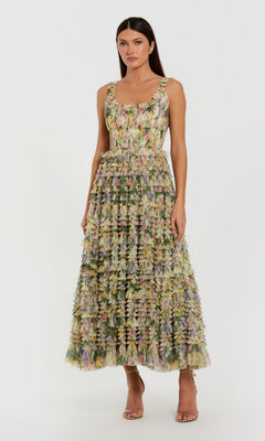 A woman wearing the Tea-Length Party Dress: Mac Duggal 8299 in Yellow Multi—an ankle-length party dress with a sleeveless design and a textured floral pattern—stands against a plain light background.