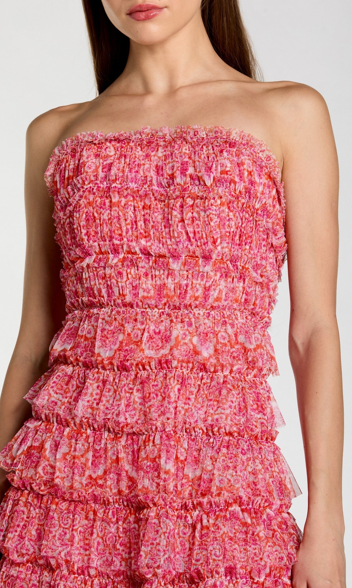 A woman wearing the Mac Duggal 8301 yellow floral wedding-guest dress, featuring ruffled, textured layers and a fitted silhouette, shown from shoulders to thighs.