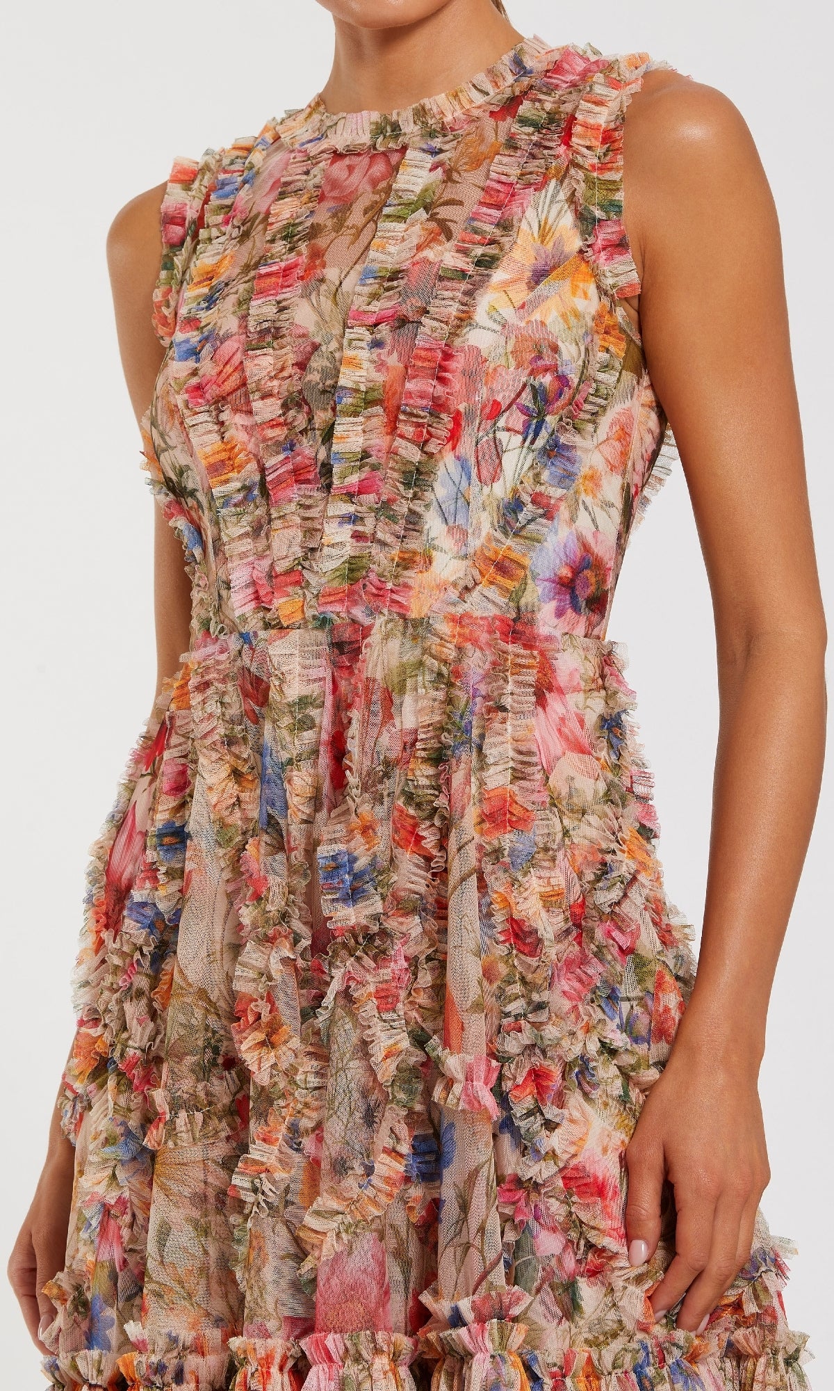 A woman poses against a plain background in the Mac Duggal 8307 High-Neck Print Wedding-Guest Dress, featuring a sleeveless design, colorful floral print, and textured ruffle details—ideal for wedding guests.