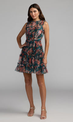 A woman wears the Mac Duggal 8307 High-Neck Print Wedding-Guest Dress featuring a fitted waist and tiered knee-length skirt, styled with strappy heels—an ideal choice for wedding guests.