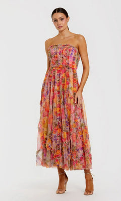 Woman in a Mac Duggal 8308 Strapless Print Midi Party Dress in Multi, standing against a white background and wearing heeled sandals.