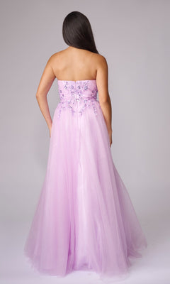 A woman with long dark hair models the Long Formal Dress: Nina Canacci 8310—a strapless, floor-length light purple gown with floral embroidery—shown from the back against a plain background.