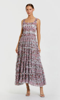 Woman wearing a patterned dress on a white background