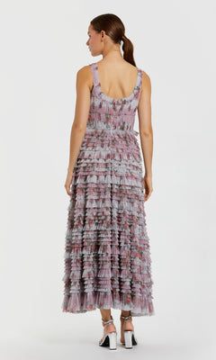 Woman wearing a patterned dress on a white background