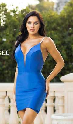 A woman stands outdoors in front of greenery and a white railing, wearing the Beaded-Strap Short Backless Homecoming Dress 832—a fitted blue dress with beaded shoulder straps, deep V-neck, and open back.