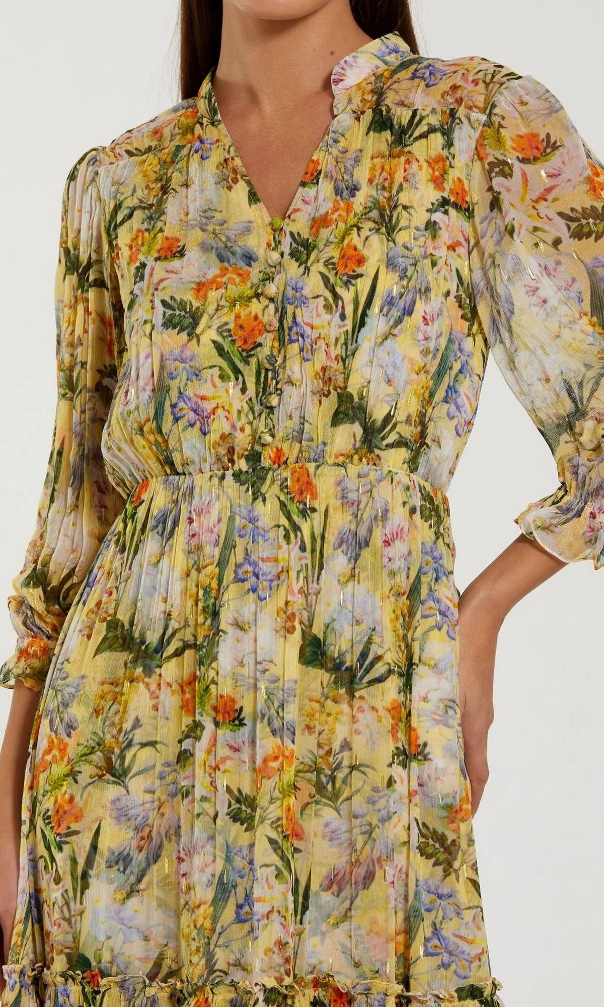 A woman wears the Mac Duggal 8335 Midi Party Dress, a yellow modest midi dress with long sleeves and a cinched waist, featuring a vibrant botanical print reminiscent of floral designs.
