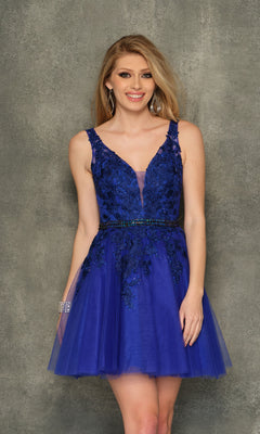 A woman wears the A-Line Short Homecoming Dress H341, featuring a sleeveless blue lace and tulle design with a deep V-neckline and beaded bodice, standing before a textured gray background.